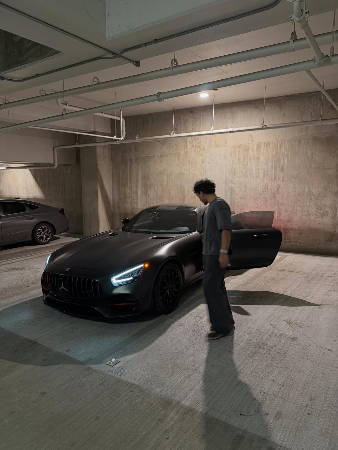 AB stepping out of his Mercedes AMG
